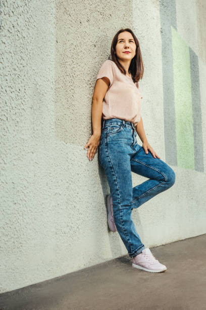 istock Attractive young woman posing against concrete wall. 1372290118
