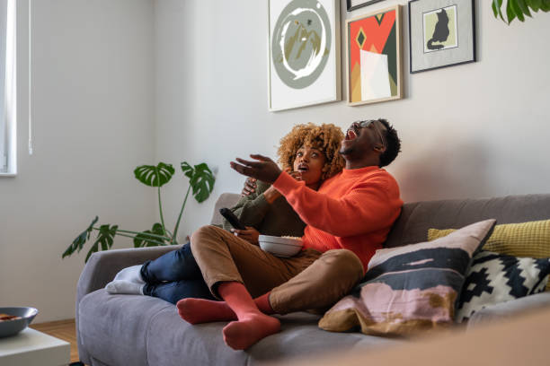 istock The couple is relaxing on the sofa and watching tv 1372290130