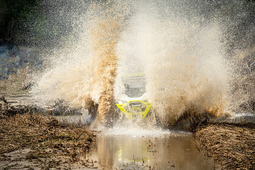 Amazing view of active ATV and UTV driving in mud water