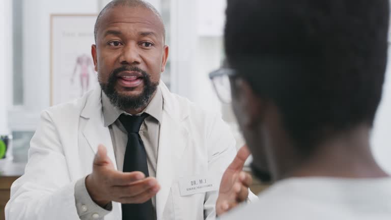 Shot of a male doctor having a consultation with a patient in an office at a clinic