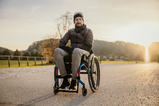istock Disabled man in wheelchair on road 1372301419