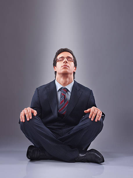 istock concentrated young businessman sitting on the floor 137230243