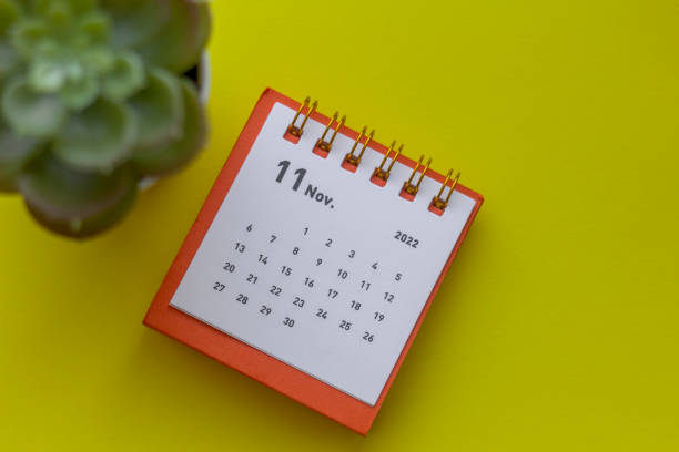 istock Desktop calendar for November 2022 on a yellow background. 1372302958