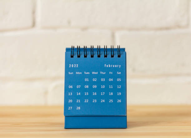 istock Desktop calendar for February 2022 on the table. 1372303476