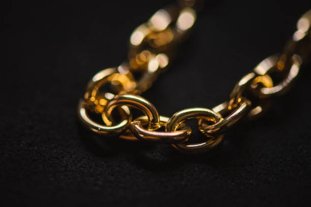 Close-up of gold chains on a black background stock photo