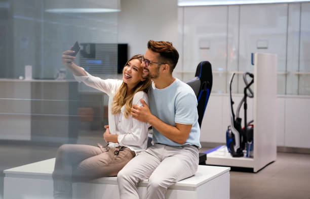 istock Young cheerful couple taking selfie together and having fun. Technology people concept 1372304073
