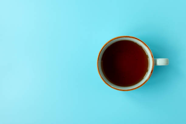 istock Cup of tea on blue background. Top view. 1372304680