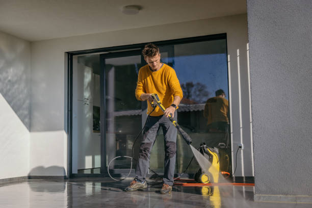 istock Man using a high pressure cleaner to clean the patio 1372306716