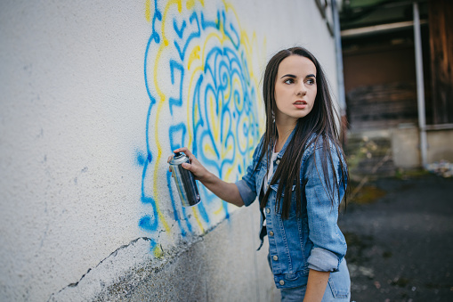 Graffiti Artist Drawing Graffiti on Wall.