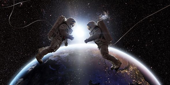 Two astronauts in full spacesuits with backpacks on a space walk with tethers, facing each other with hands out. They are floating in the front of Planet Earth as the sun rises between them. 

Background images credit: NASA https://eoimages.gsfc.nasa.gov/images/imagerecords/90000/90008/europe_vir_2016_lrg.png and ESO