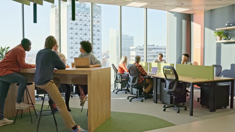 Businesspeople meeting informally in modern open plan office