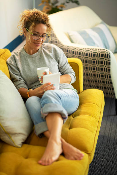 istock Smiling Woman Relaxing On Sofa At Home 1372313463