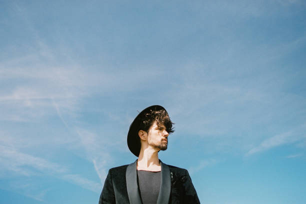 istock Low Angle View Of Young Man Standing Against Sky 1372314237