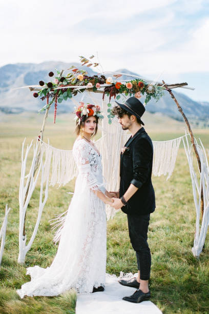 istock Rear View Of Bride And Bridegroom Standing By Plants 1372314907