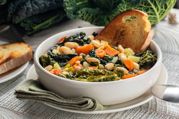 Close-up of Tuscan vegetarian bread Soup made with toasted bread and vegetables. Ribollita. Cannellini beans, lacinato kale, cabbage verza, carrot, celery, potatoes, and onion. Itralian food. stock photo