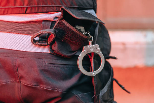 istock Handcuffs hanging from policeman duty belt 1372319569