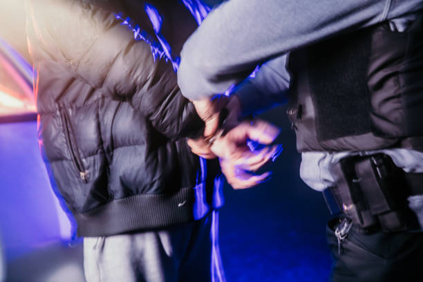 istock Police officer arresting a young gangster 1372319621