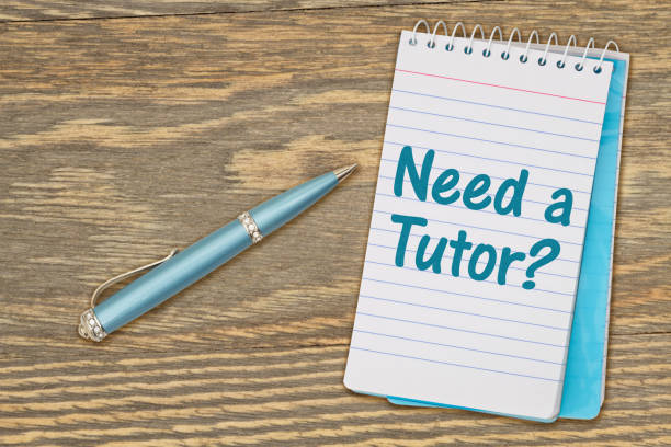 istock Need a Tutor message on retro lined paper notepad on a weathered wood desk 1372319940