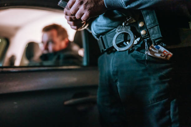istock Traffic cop taking a bribe from the stopped driver at night 1372320055