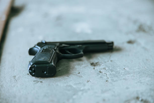 istock Semi-Automatic pistol lying on the concrete floor 1372320658