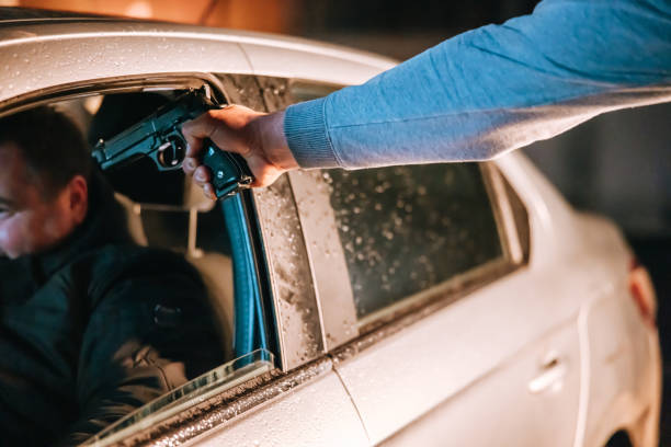 istock Policeman aiming a gun to a stopped driver at night 1372320683