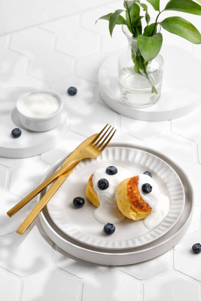 istock Summer sunny breakfast with dessert. Creative and minimalism. Tile and white. Gold tableware 1372320710