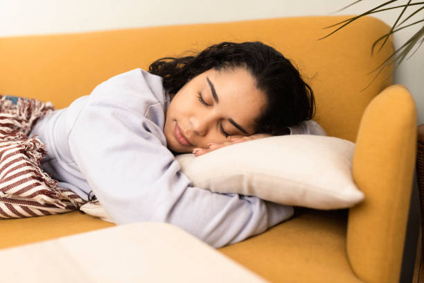 istock Young woman taking a nap on the sofa 1372320849