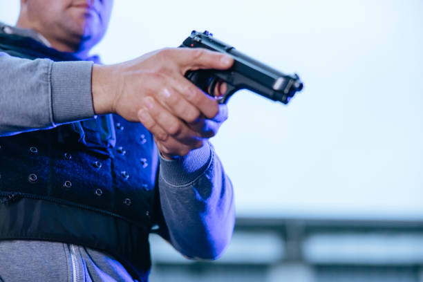 istock Policeman taking the pistol for aiming at the target 1372322043