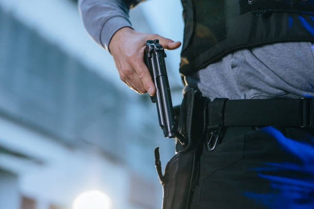 istock Task force officer putting a pistol into a gun holster 1372322142