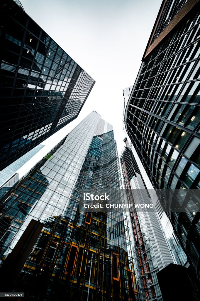 Looking directly up at the skyline of the financial district in central London Abstract Stock Photo