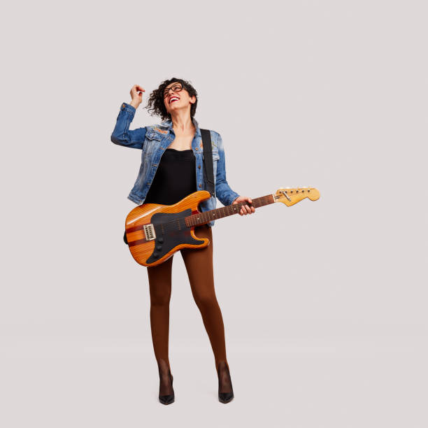 Let's Rock. Joyful rock star with electric guitar Cheerful female rock musician enjoys the music with electric guitar on white background guitarist stock pictures, royalty-free photos & images