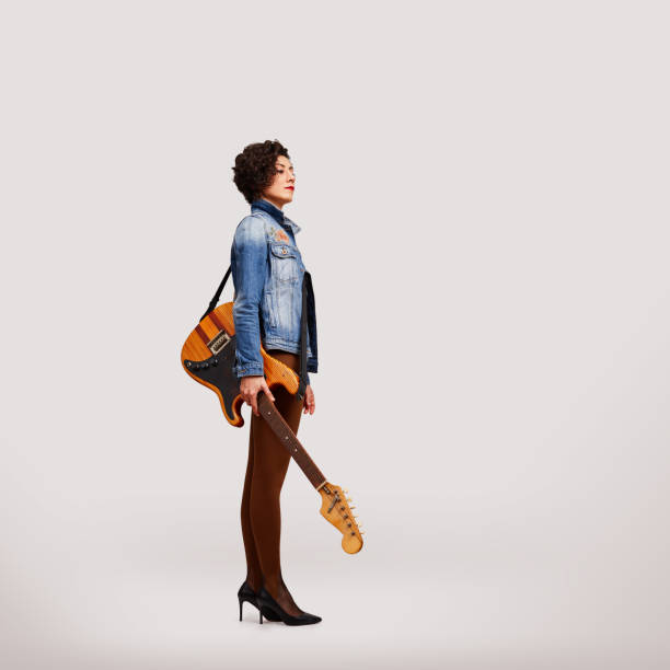 Corpulent young female guitarist with an electric guitar  isolated on white background