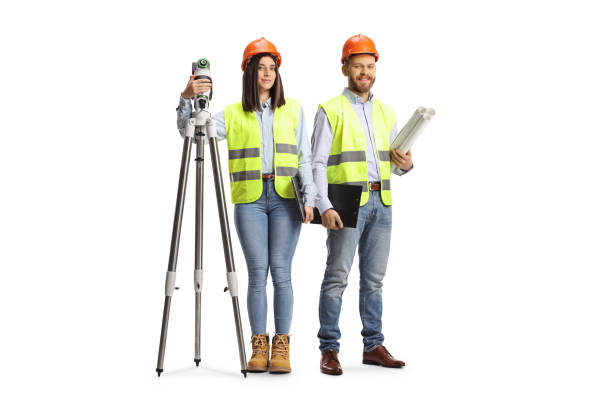 istock Female geodetic surveyor with a measuring device and a male engineer posing 1372322837