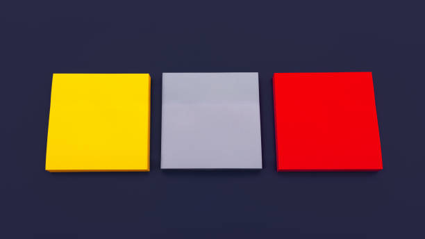 istock Three blank multi colored square stickers on dark blue background, top view. Blank space for future important events announcements 1372323772