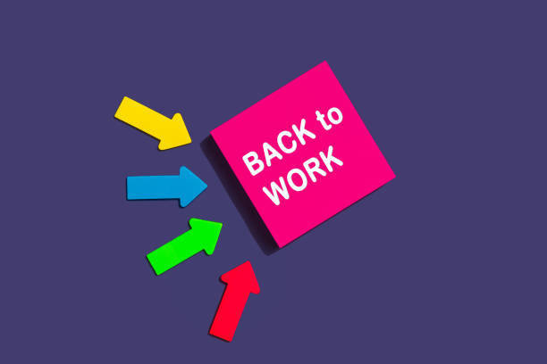 istock Back to work - concept of text on sticky note. Pink square sticky note and colorful arrows on purple background, top view 1372323819