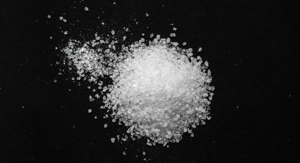 istock White coarse sea salt on a black background 1372323982