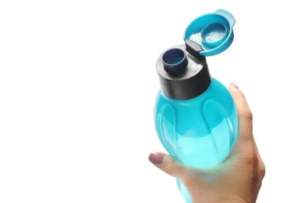 Photo of Woman holds eco bottle classic blue color. Tool for fitness.