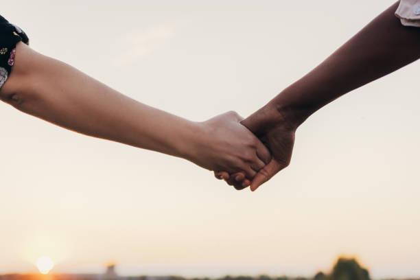 istock Mixed ethnicity women holding hands 1372330294