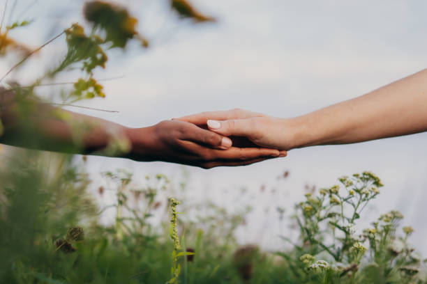 istock Interracial women holding hands 1372330351