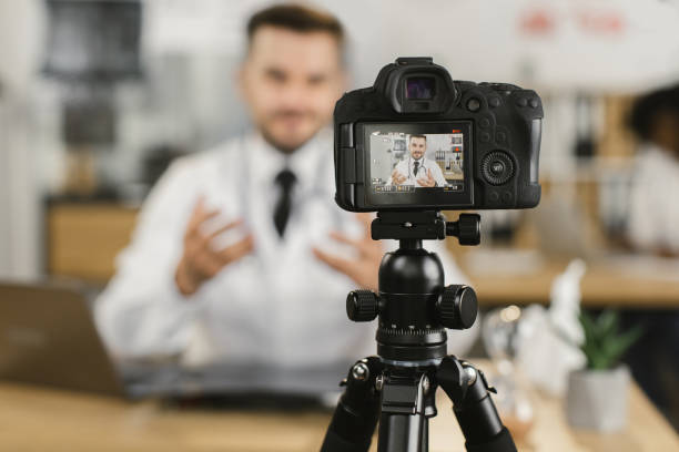 istock Qualified doctor using laptop and camera for recording video 1372330505