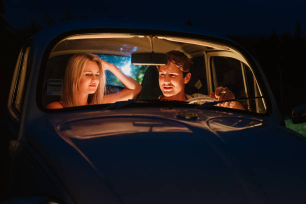 istock Happy young couple sitting in car during date 1372330730