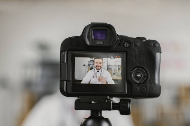 istock Competent therapist recording video about pills for his vlog 1372330851