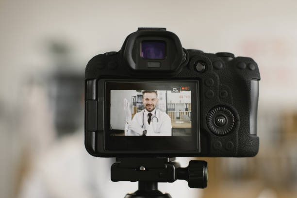 istock View on camera screen with doctor putting on rubber gloves 1372331568