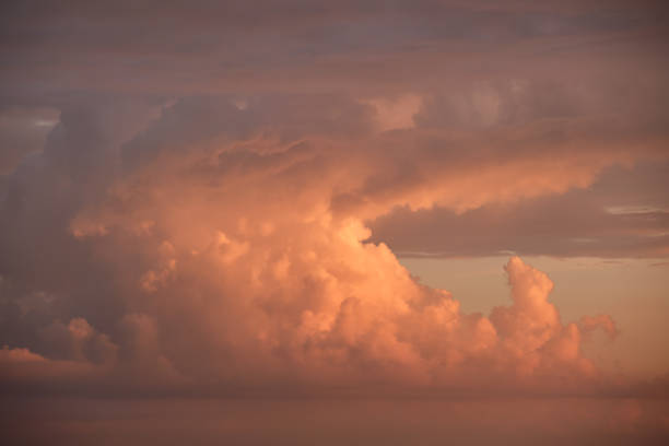 istock Bright colorful sunset sky with vivid smooth clouds illuminated with setting sun light spreading to horizon 1372332081
