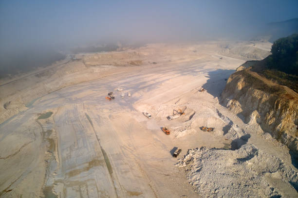 istock Aerial view of open pit mining of limestone materials for construction industry with excavators and dump trucks. 1372332209