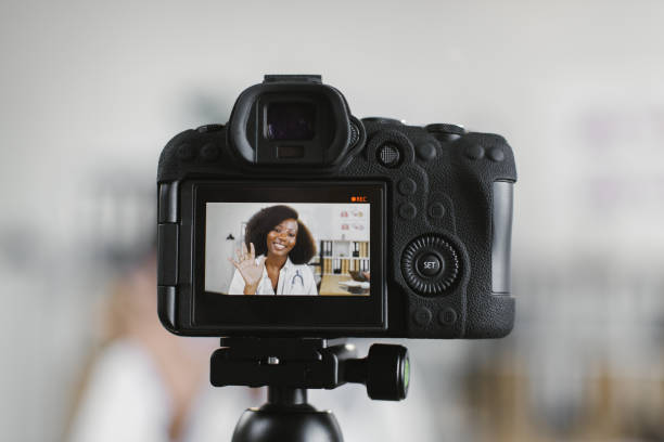 istock Video camera screen with smiling african female doctor 1372333585