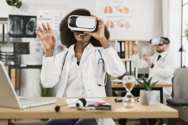 istock Two multicultural male and female doctors using VR goggles 1372334935
