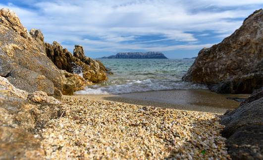 Sardinia rocky coast with sea view and island isola tavolara