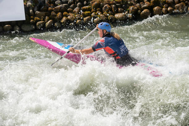 istock Great Britain canoe slalom athlete paddles through white water 1372337275