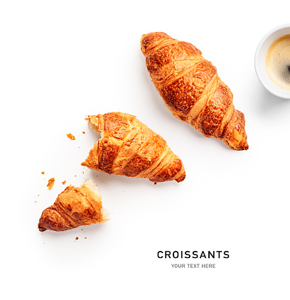 Fresh croissant and coffee cup creative layout isolated on white background. Healthy eating and sweet food concept. French breakfast. Flat lay, top view. Design element